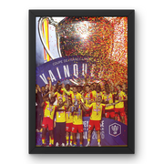 Vue rapprochée d’un cadre noir avec affiche du RC Lens vainqueur de la Coupe de France 2026, montrant les joueurs en célébration avec le trophée.